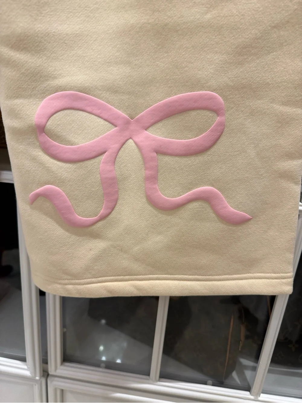 Edikted Cream/Light YellowTrack Pants with Pink Bow Detail on back of pants.